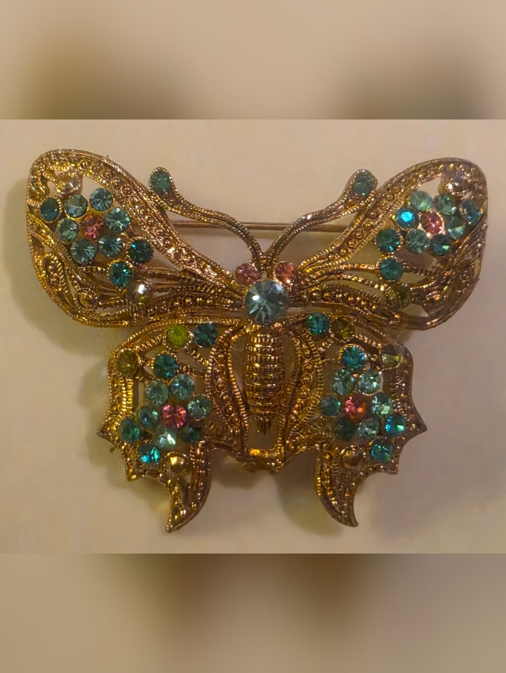 Vintage-style gold-tone filigree butterfly brooch with rhinestones